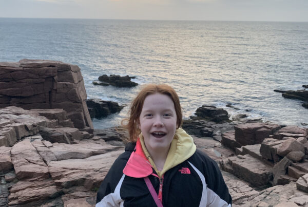 Cameron on the rocks near the edge of the ocean after a wonderful sunrise near Thunder Hole in Acadia National Park.