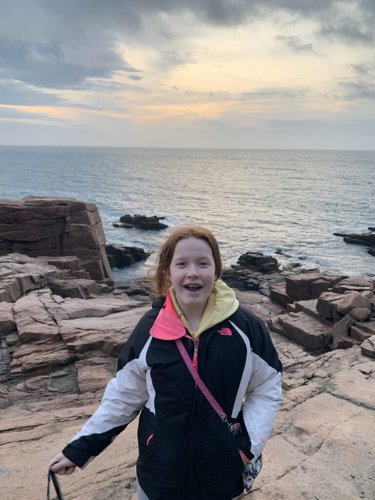 Cameron on the rocks near the edge of the ocean after a wonderful sunrise near Thunder Hole in Acadia National Park. 