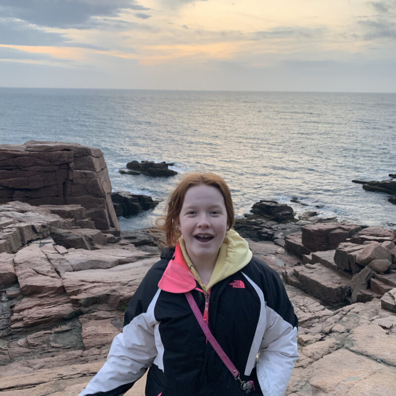 Cameron on the rocks near the edge of the ocean after a wonderful sunrise near Thunder Hole in Acadia National Park.