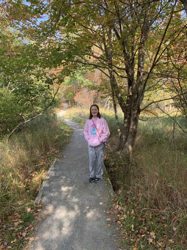 Cameron hiking down Jesup Path at the peak of the fall colors in Acadia National Park.