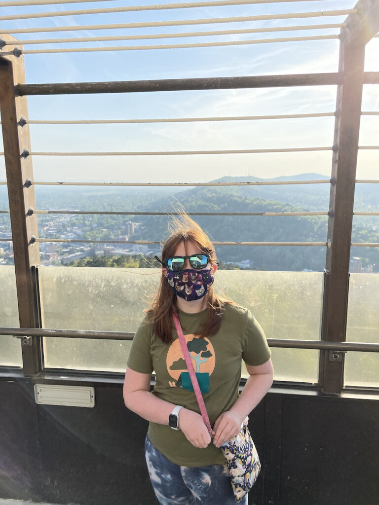 Cameron on top of Hot Springs Mountain Tower wearing sun glasses and having her hair blown all around. From here you can see 360 degrees around the entire town and surrounding area. 