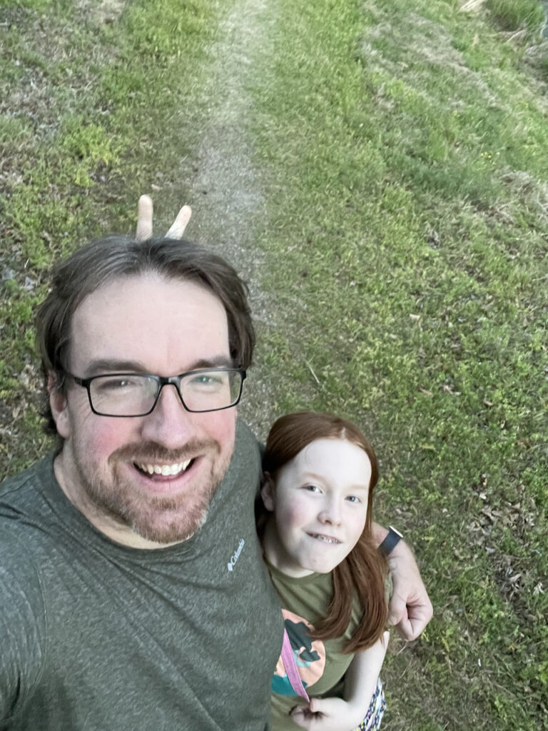 Cameron and myself pose for a selfie smiling while she gives me bunny ears.  Taken on a trail in Hot Springs National Park.