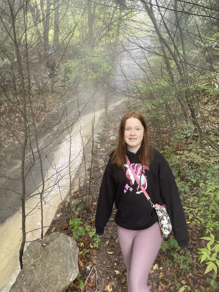 Cameron standing in the woods just off the Peak Trail in Hot Springs National Park. There is a massive stream of spring water that runs down the hill here and the air is full of steam from all the springs.