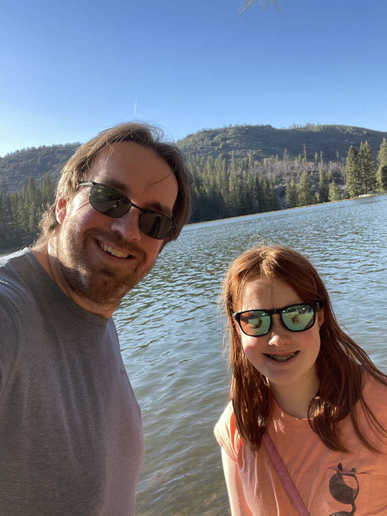 Cami and myself both wearing sunglasses and big smiles on the shores of Hume Lake. 