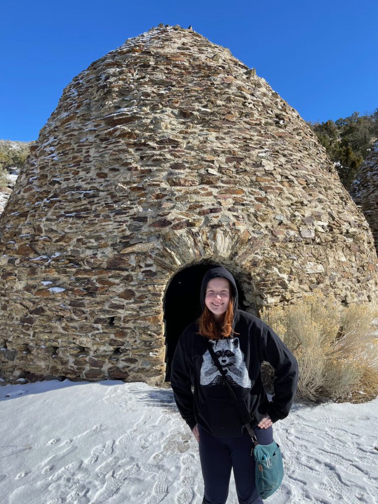 Cameron standing in the snow, next to the massive Wildrose Charcoal Kilns in Death Valley.