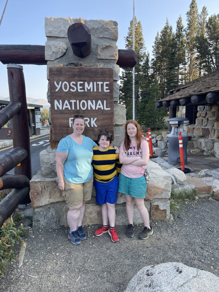 Cat, Cameron and Collin in front of the Yosemite National Park sign on Tioga Pass on the eastern side of Yosemite.