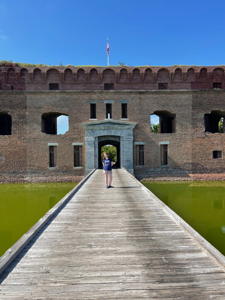 Cameron standing on the main bridge over the moat to the front gate of Fort Jefferson.