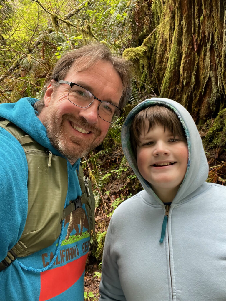 Collin and myself taking a photo, both all smiles in the rain forest on the Sweet Creek Falls trail.