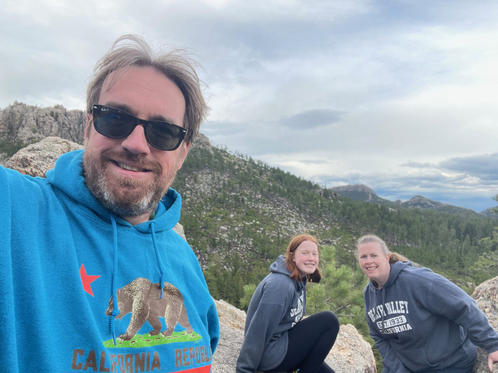 Cameron, Cat and myself in a photo from a high vantage point in Custer State Park, looking over at the Cathedral Spires. 