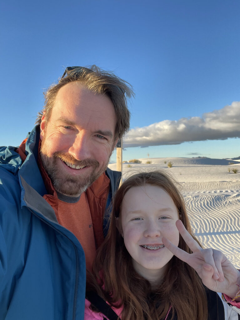 Cameron making a peace sign and myself on the sands dues mid day. A single massive cloud hovers overhead and the long shadows are starting to forum on the dunes. 