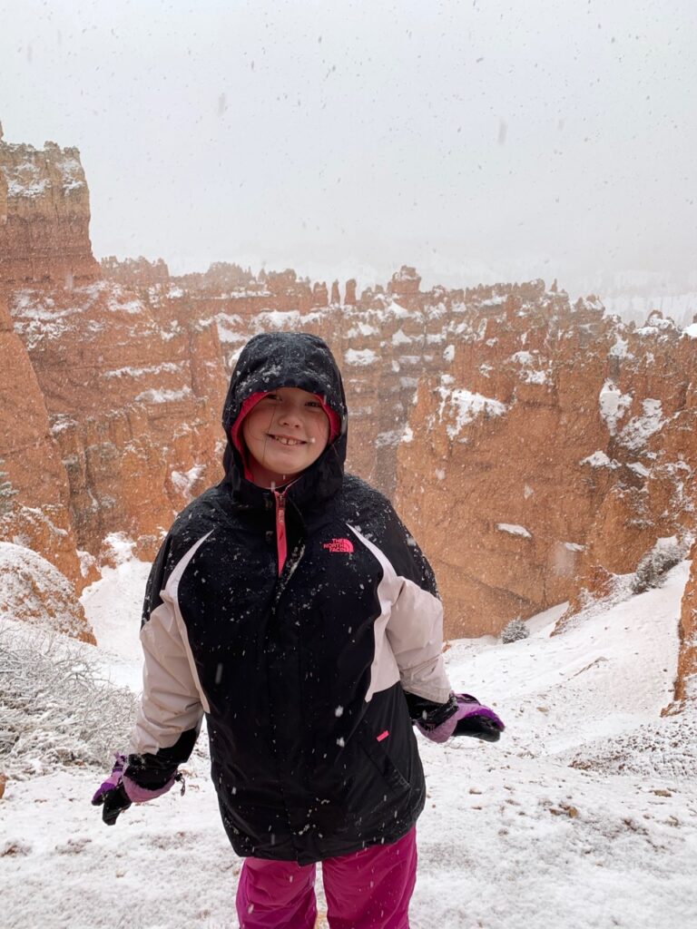 Cameron standing in the snow storm on Navajo Loop Trail, near sunset point in Bryce Canyon National Park.