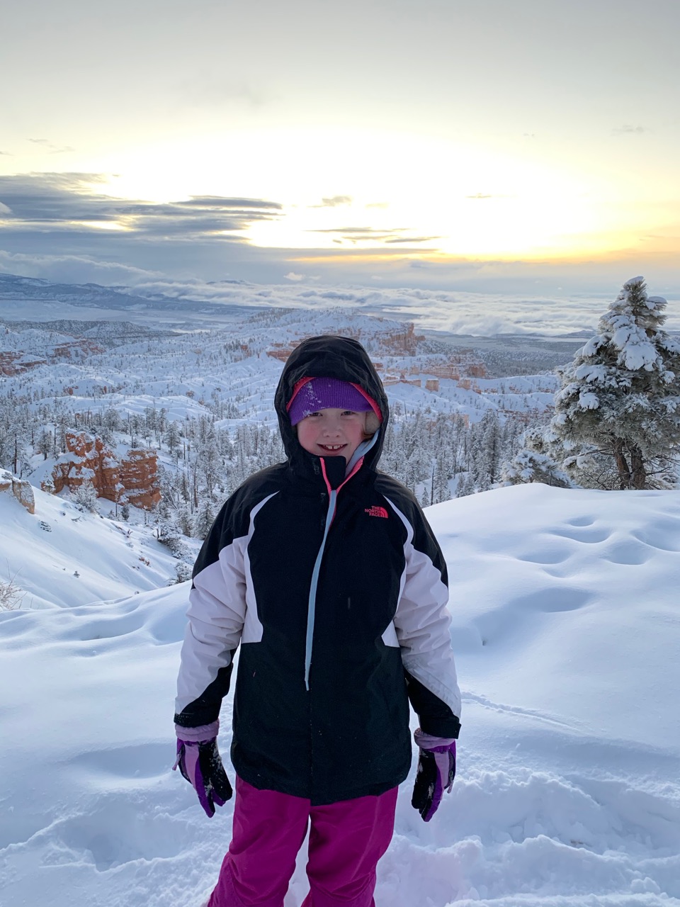 Cameron standing at a stunning sunrise in the deep and fresh snow in Bryce Canyon National Park. Taken near Sunset Point.