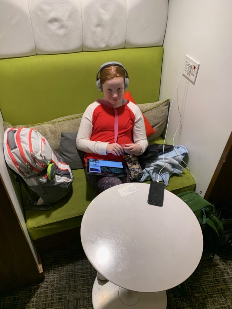 Cameron sitting and watching her ipad in the Centurion Lounge in Las Vegas Airport (LAS)