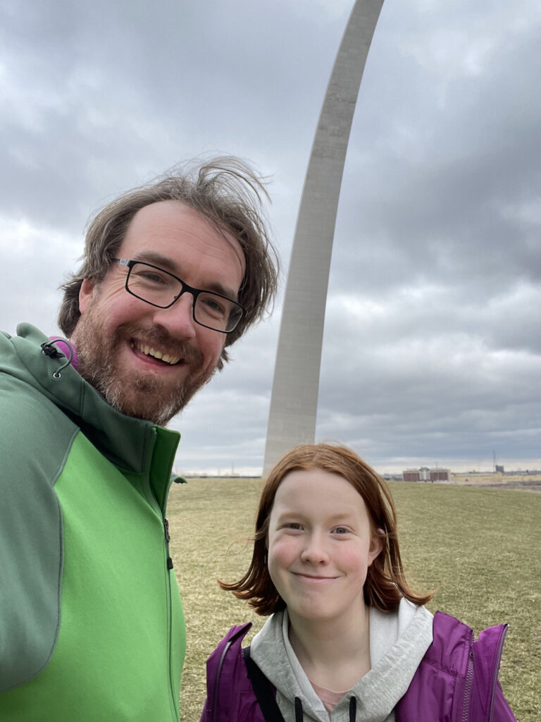 Cameron and myself in the grassy park right in front of the Gateway arch, with storm clouds above us.