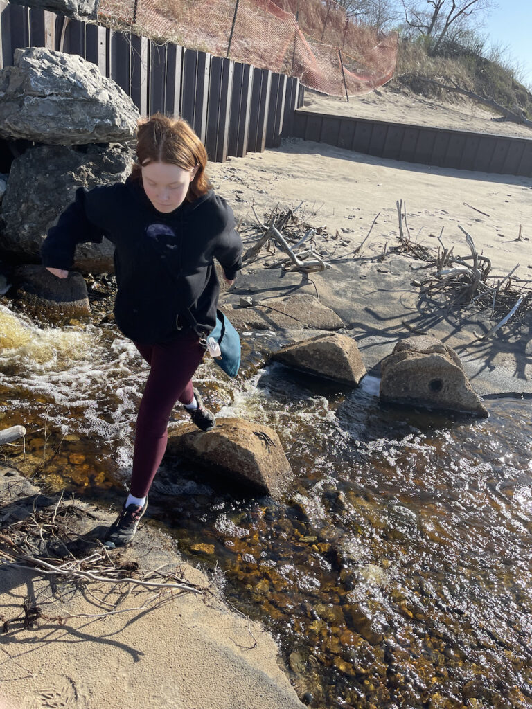 Cameron, mid air jump between rocks making he way over a little creek that feed into Lake Michigan. 