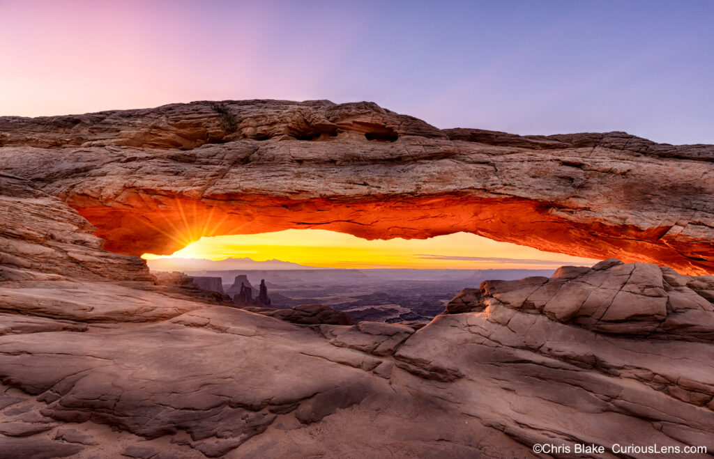 Sunrise at Mesa Arch in Canyonlands National Park with glowing arch and stunning sky.