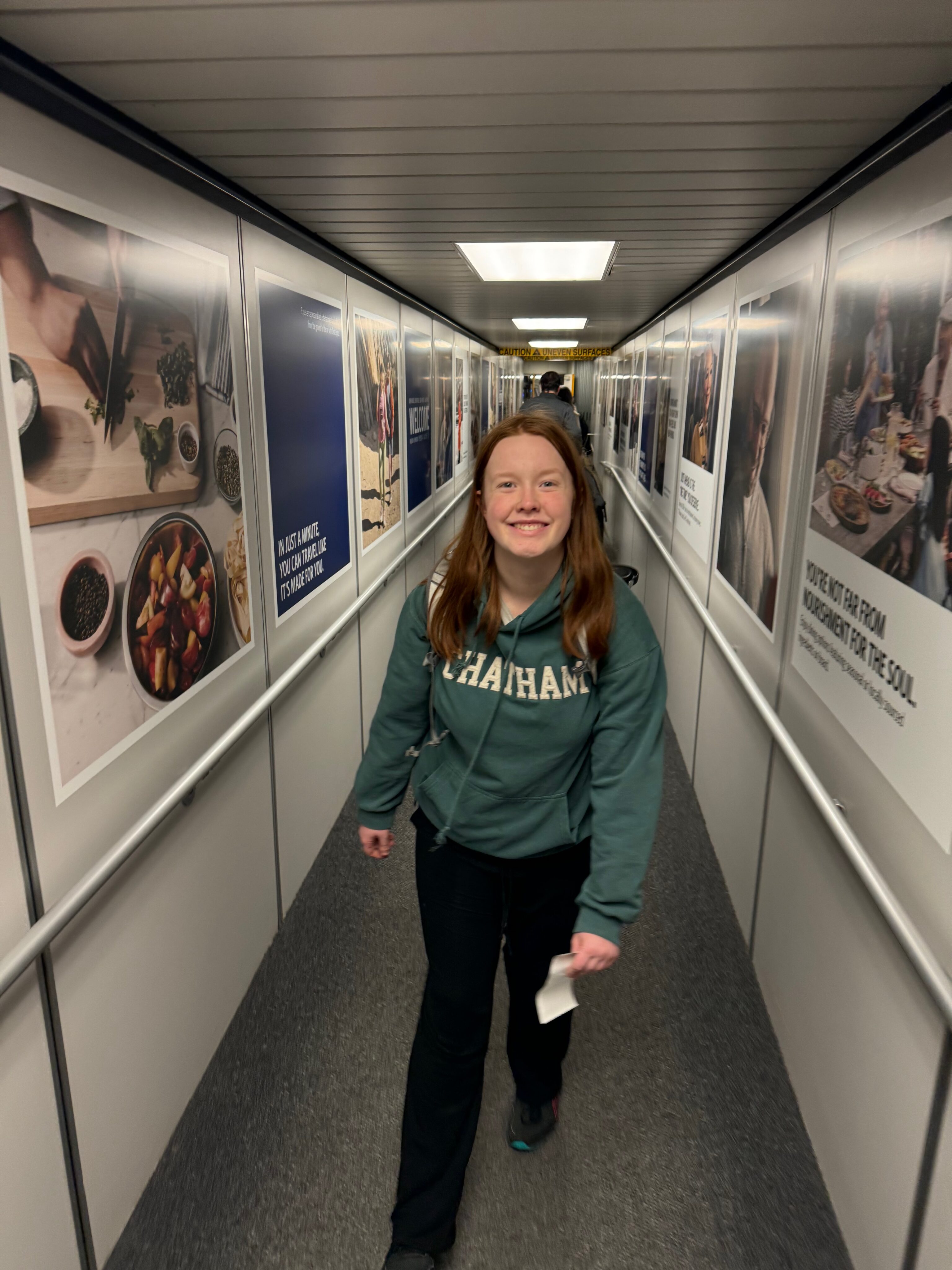 Cameron wearing a green hoodie walking backwards down the jet bridge to board the JetBlue flight to go to Las Vegas ans then Zion. 