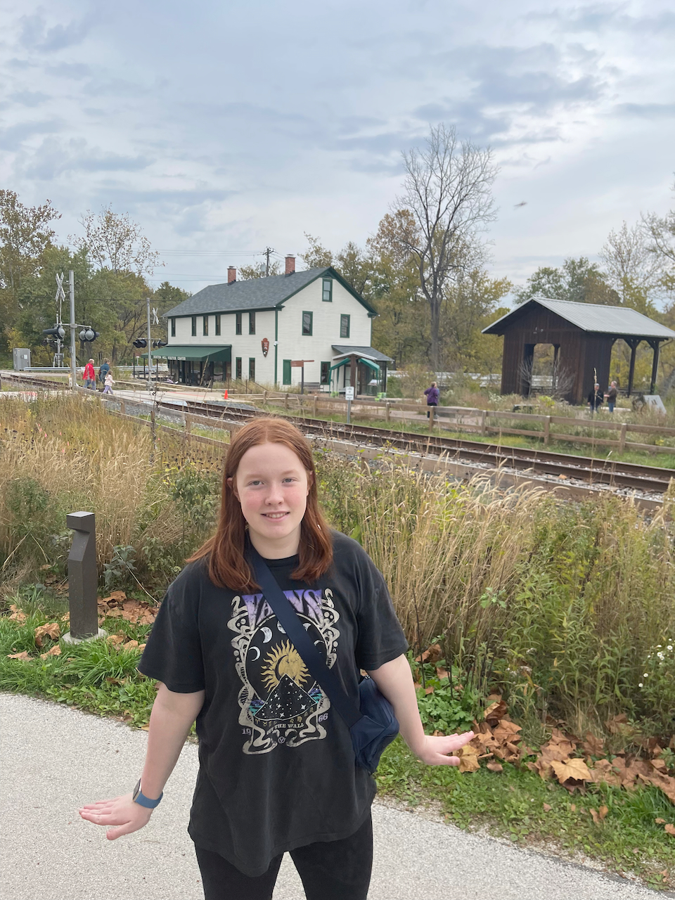 Cameron posing for a photo on a side walk, near the old train station and the Cuyahoga Valley Visitors Center.