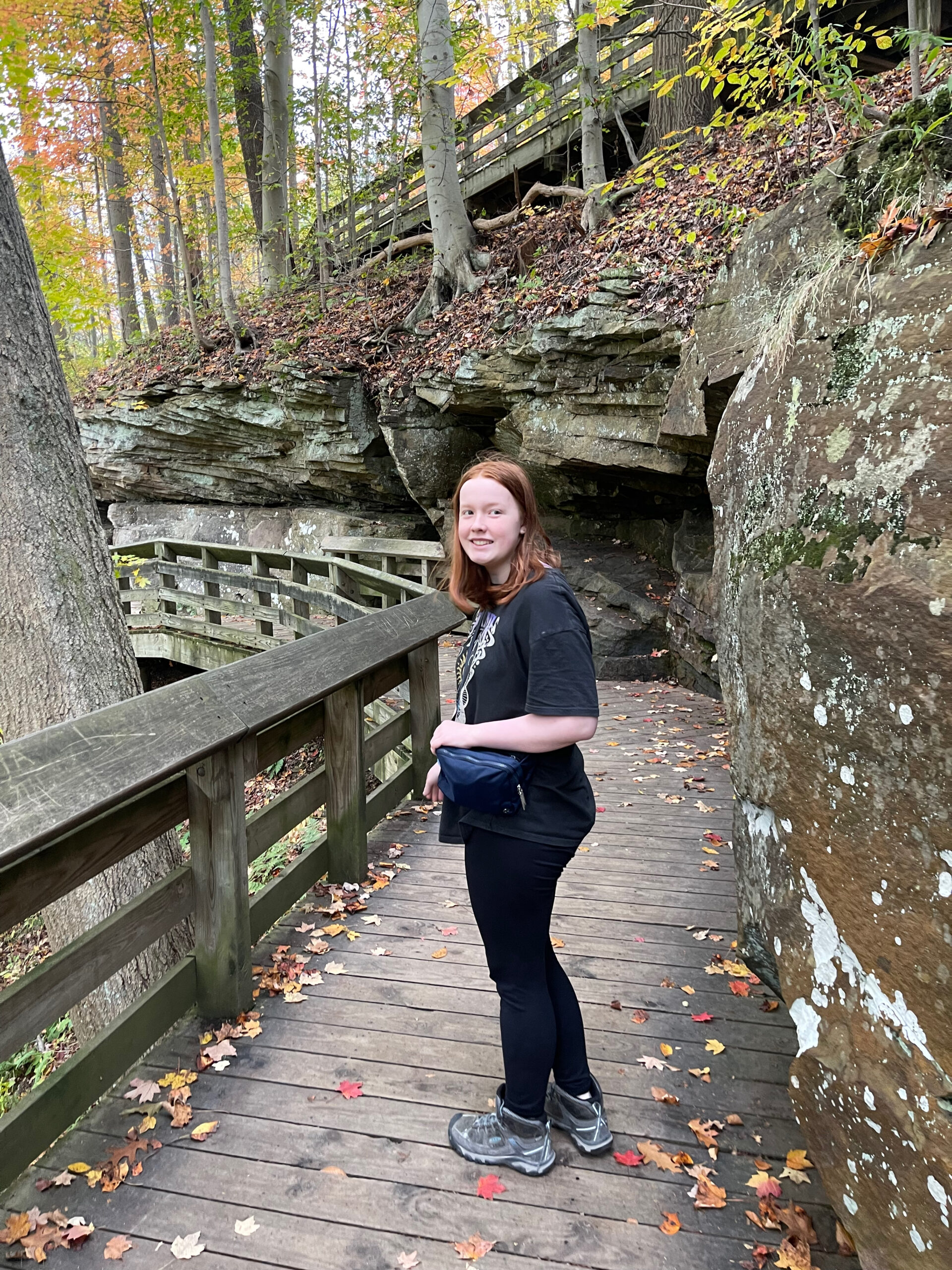 Cameron at the bottom of the Brandwine Gorge Tail. Stopping for a photo on the raised wooden boardwalk with fall color and leafs on the ground.