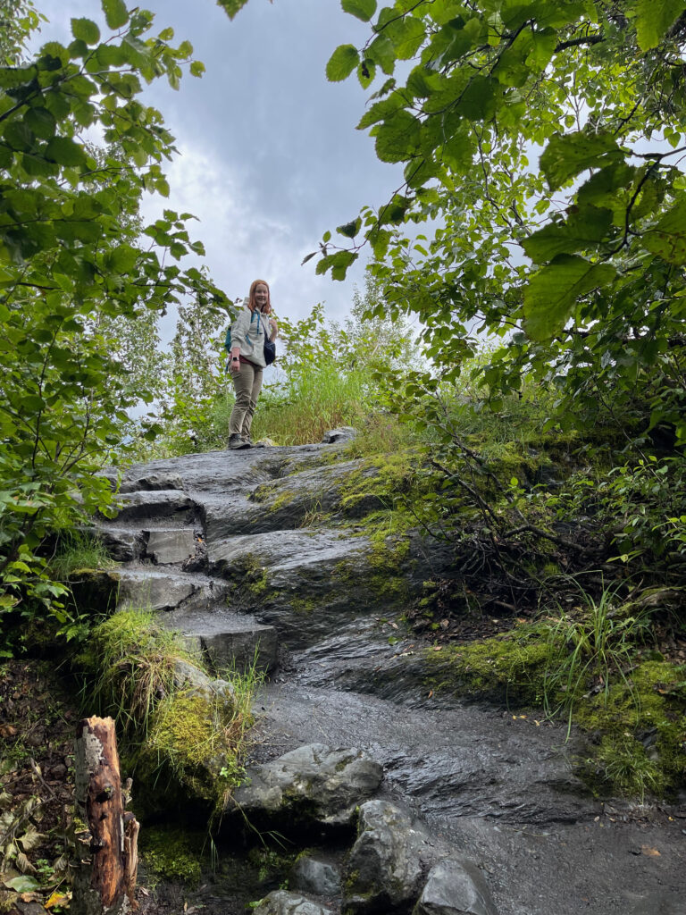 Cameron well above me as she made her way up the wet rocks and is standing 20 feet higher then me on the Exit Glacier Trail.