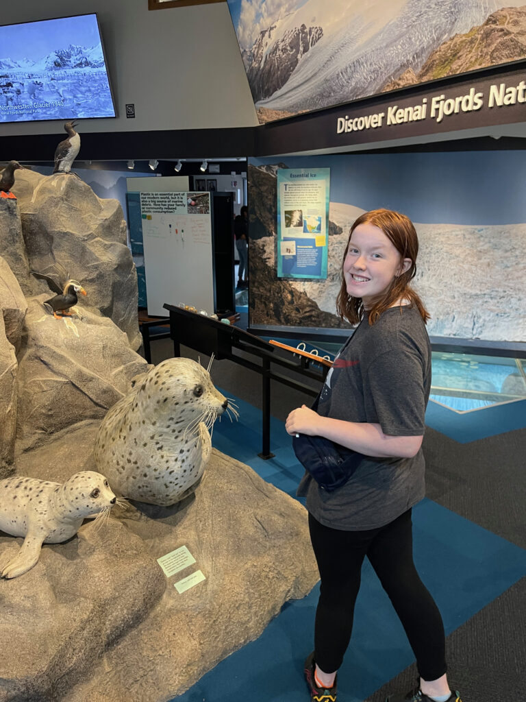 Cameron all smiles as she walks around the museum exhibits in the Kenai Fjords Visitors Center.