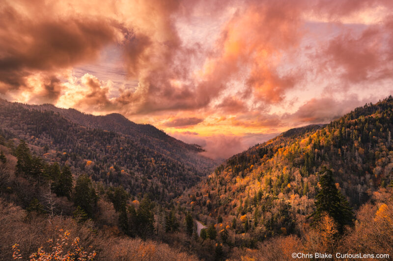 Morton Overlook at sunset in Great Smoky Mountains National Park with colorful clouds, soft light over valley, and fall colors on trees."