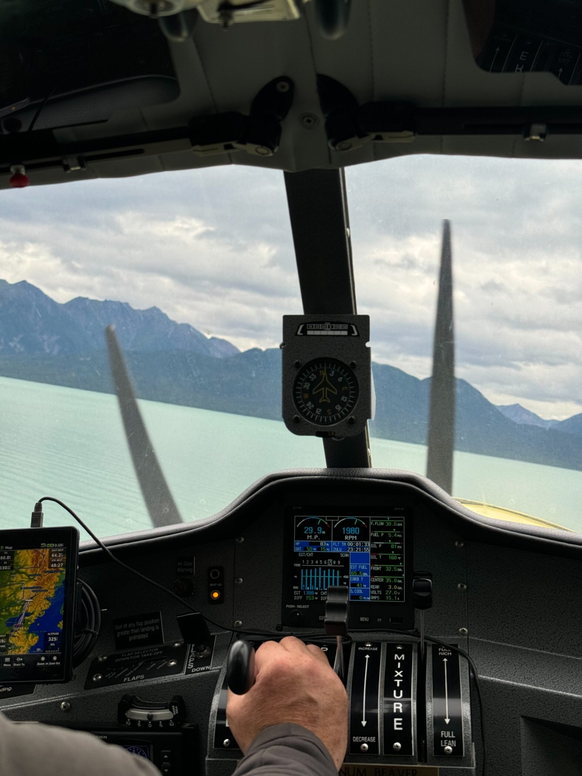 A view of Lake Clark and the controls of the de Havilland Beaver taken while flying over lake clark. 