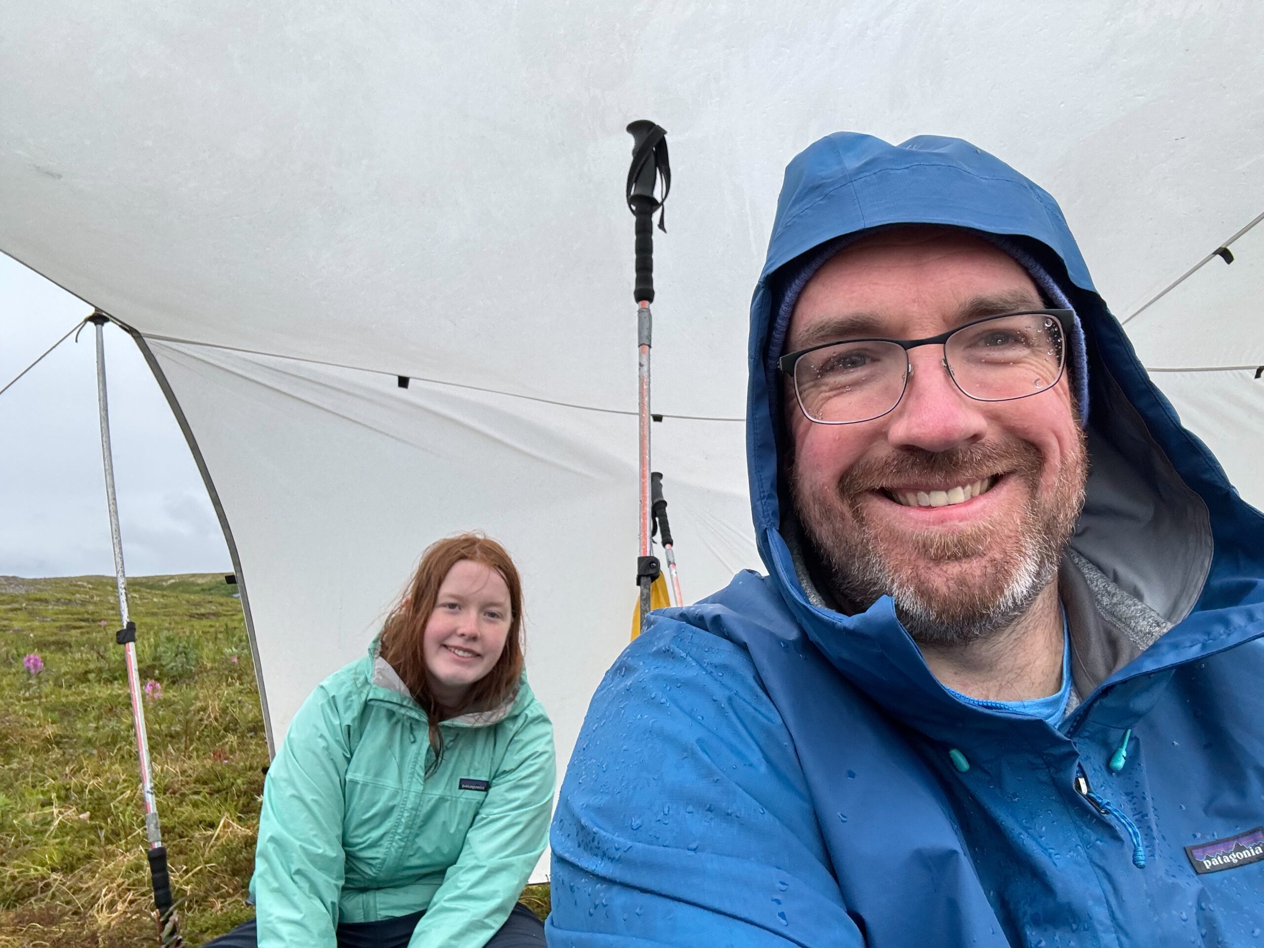 Cameron and myself, sitting under the make shift rain cover - in the cold poring rain in Katmai National Park.