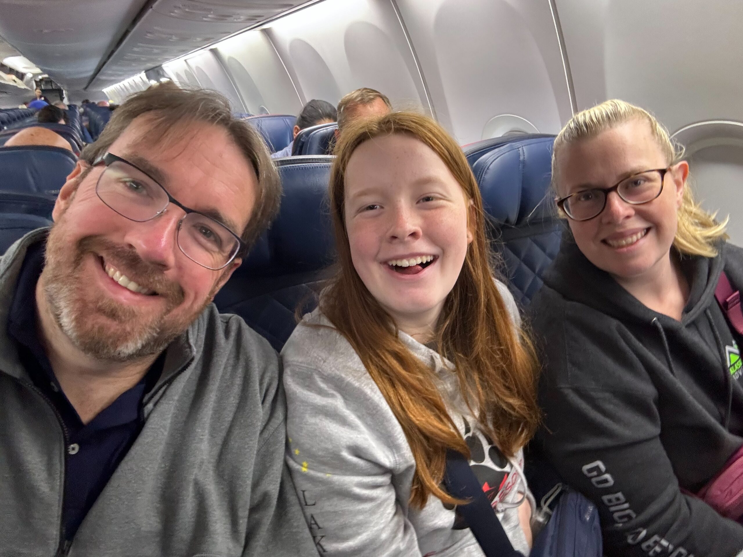 Cat, Cameron and myself all smiles in our seats on our Delta flight back home.