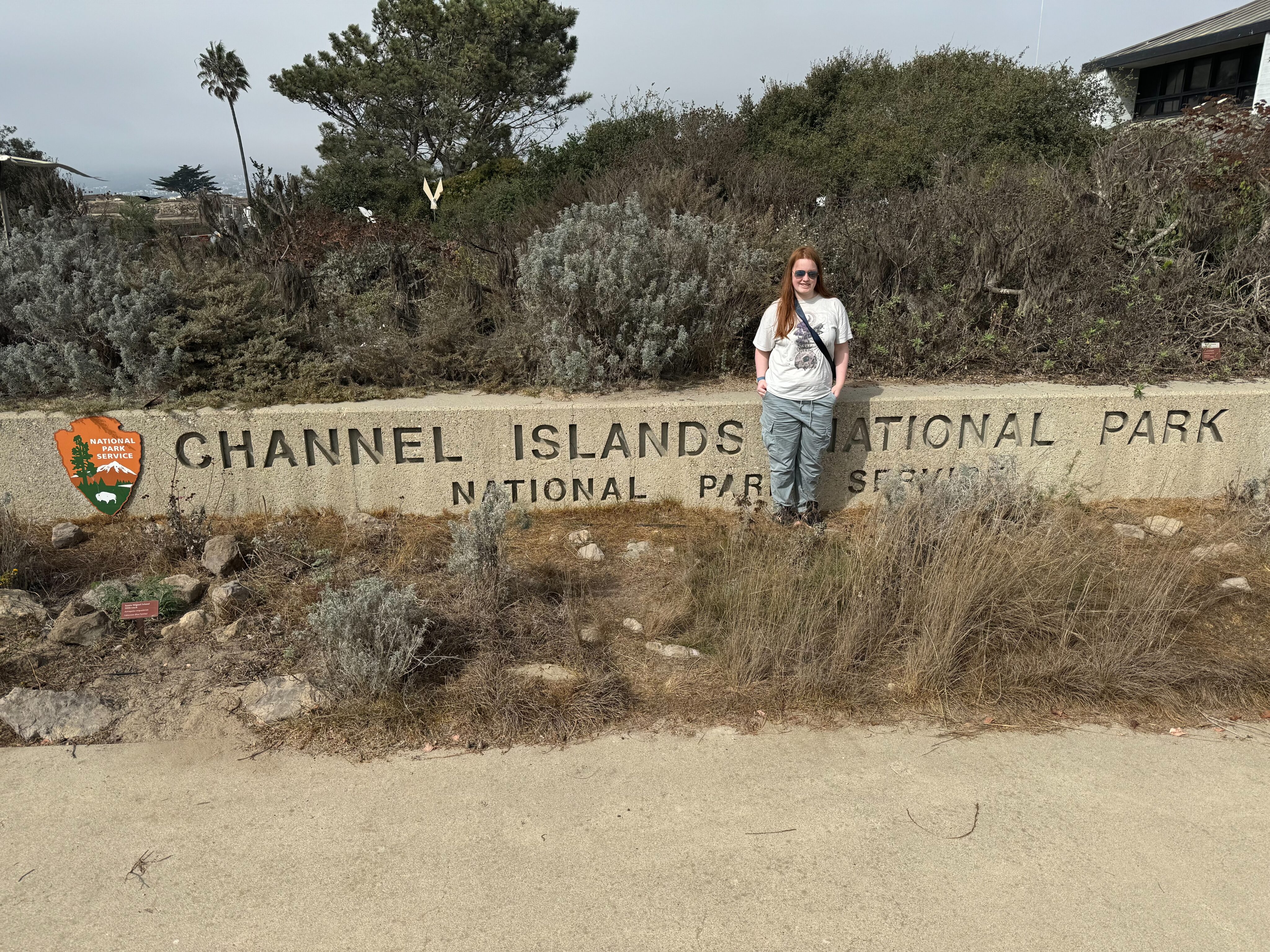 Cameron standing in front of the Channel Islands National Park sign. Outside the visitors center in Oxnard California. 