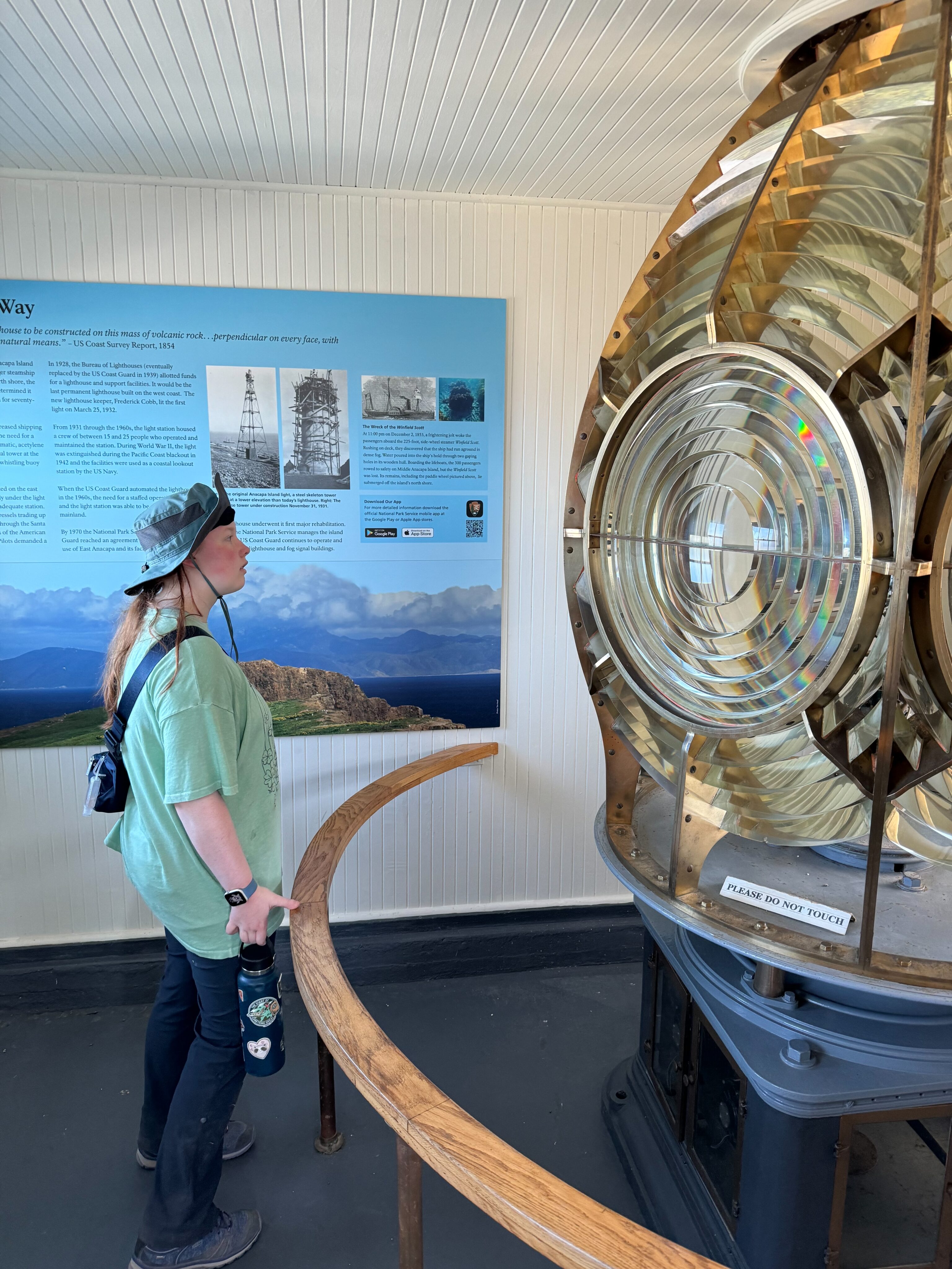 Cameron inside the visitors center on Anacapa island, looking at the massive original lens to the lighthouse.