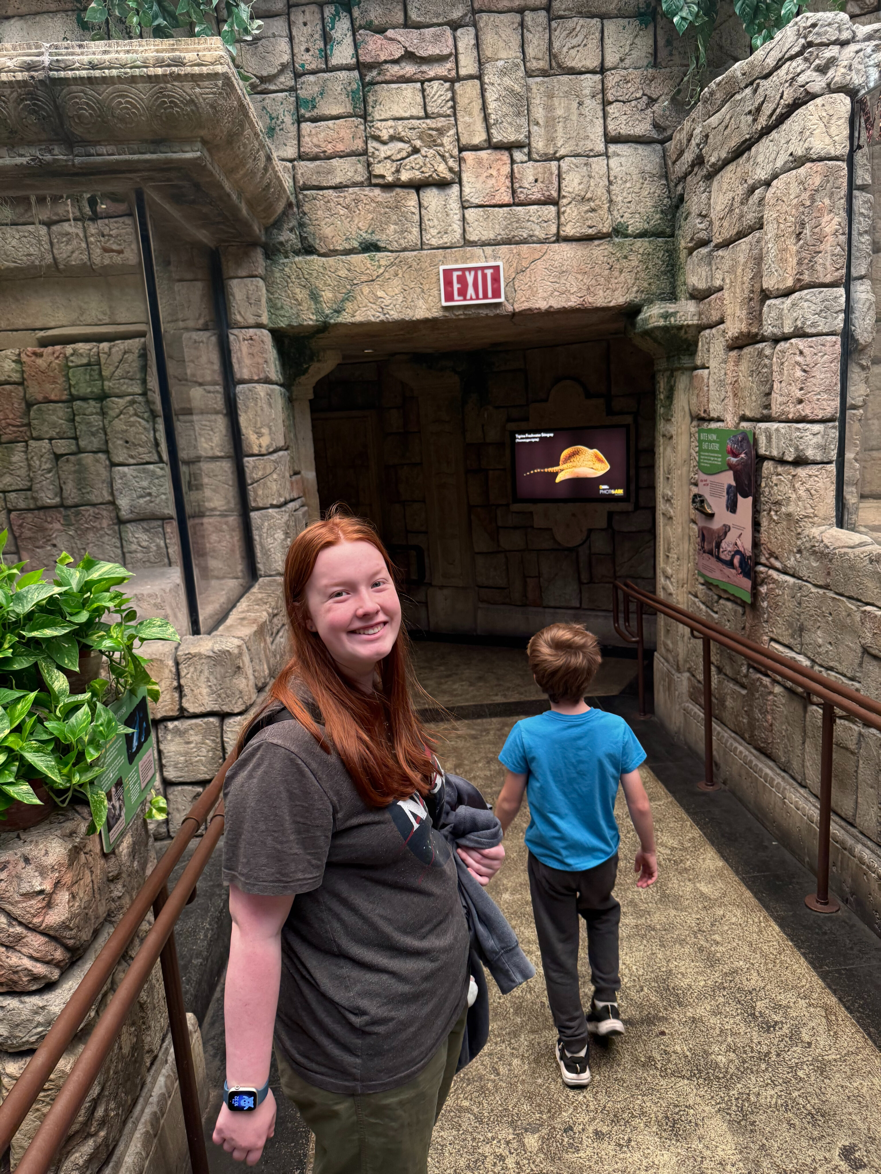 Cameron and Nate walking into down the hall inside the Shark Reef Aqarium.