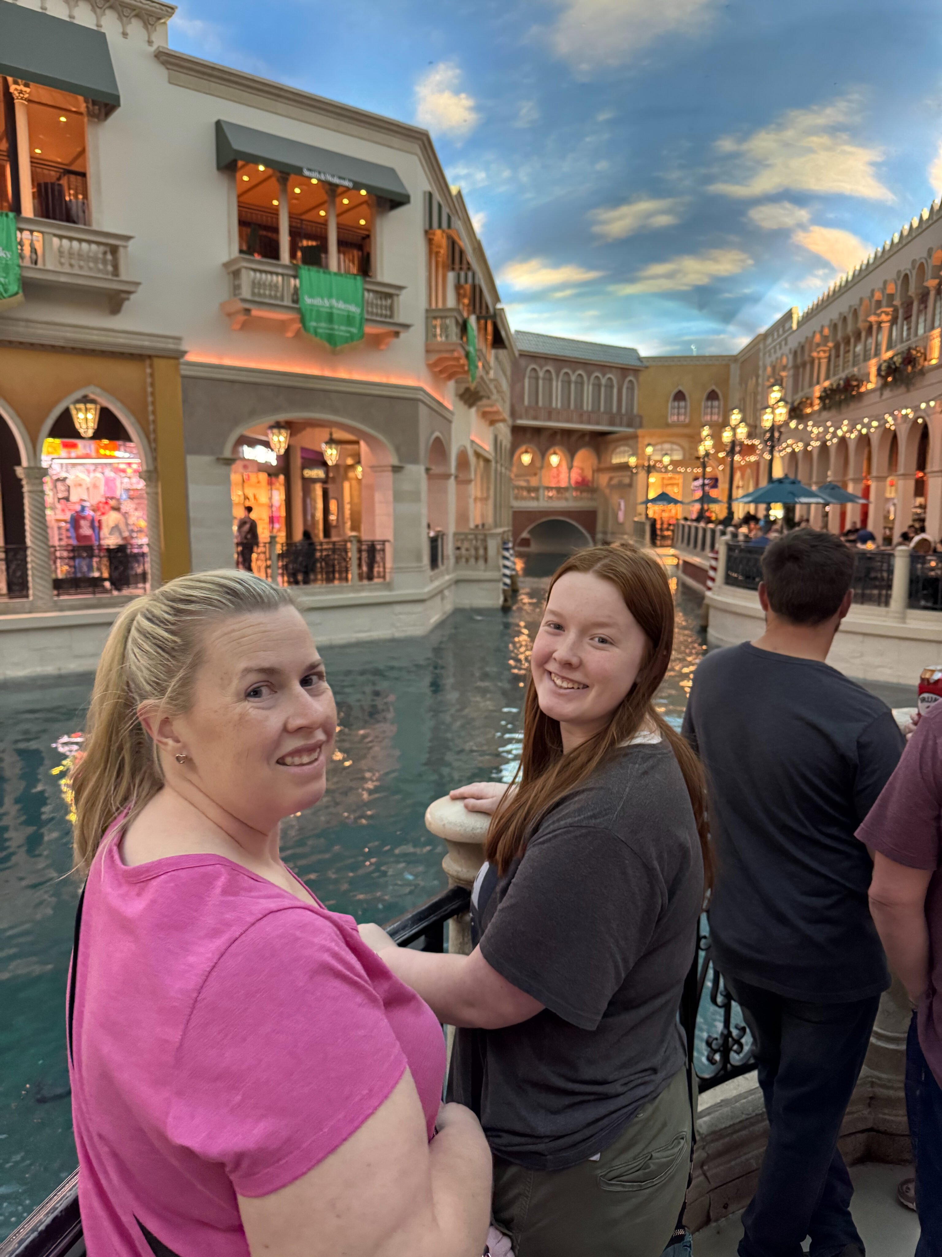 Cat and Cami in The Venetian mall, standing in front of the massive indoor canal with the fake sky overhead and shops around us.