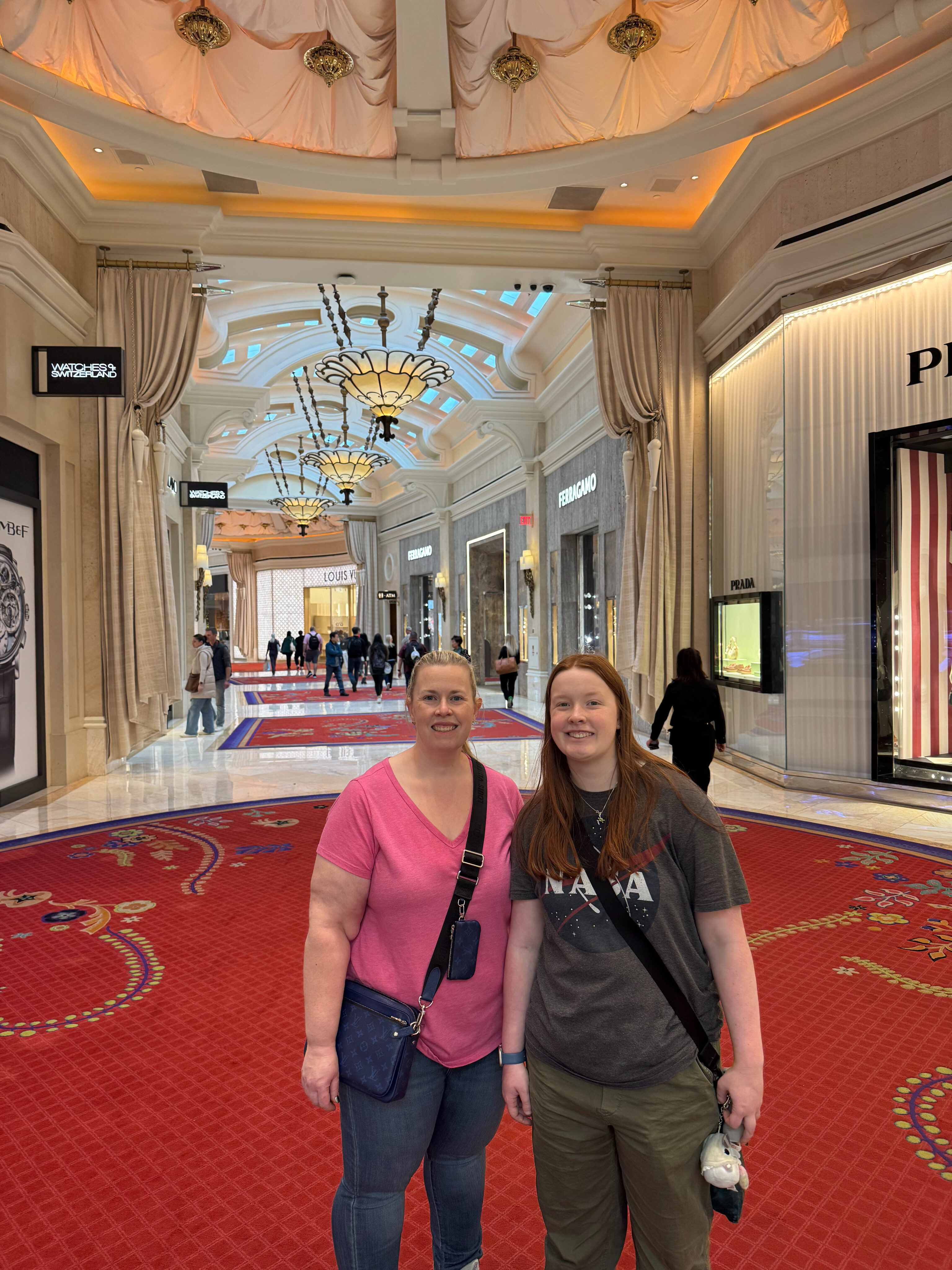 Cat and Cameron smile at the center of the fancy mall at The Wynn. 