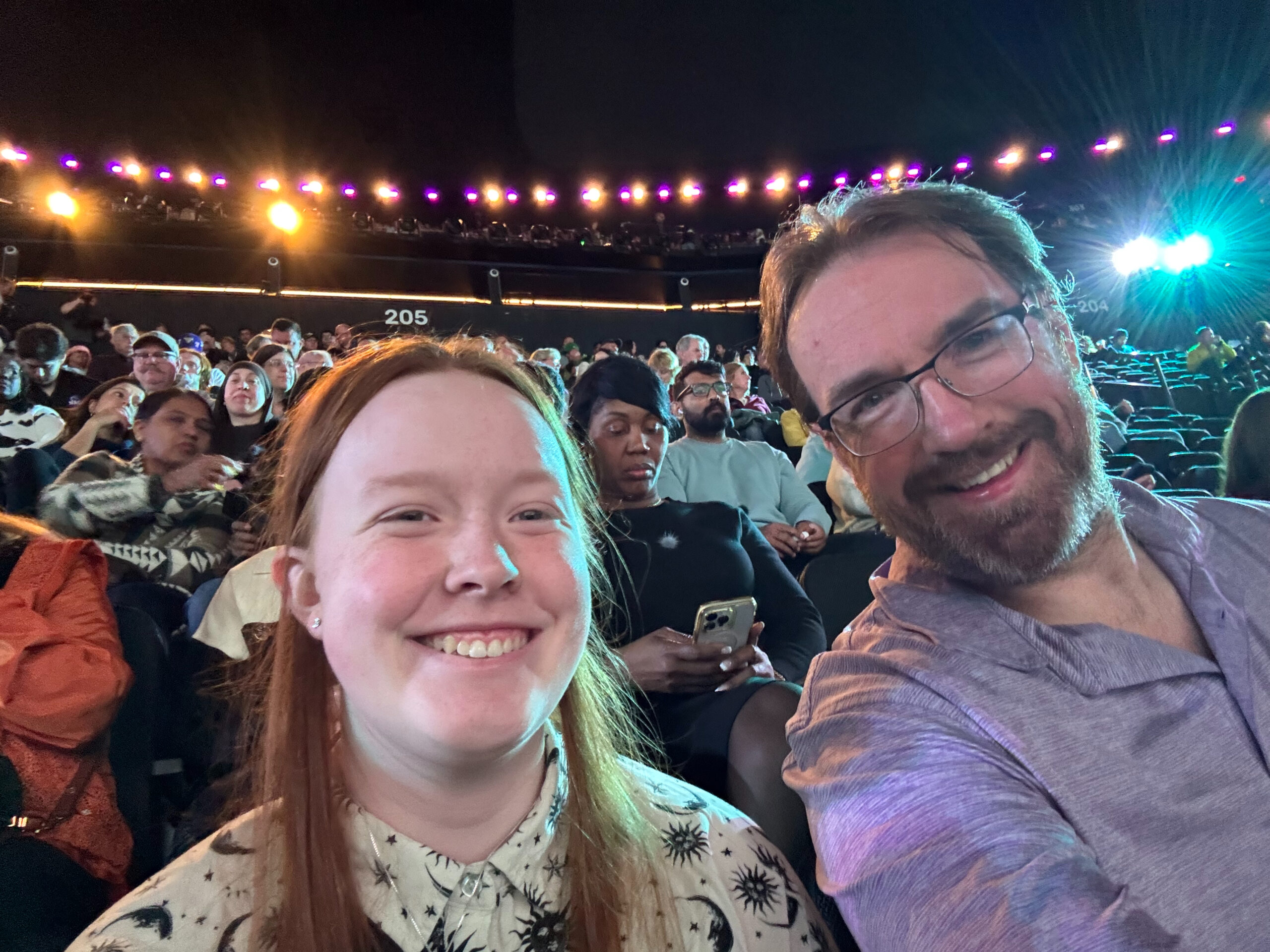 Chris and Cameron pose for a photo in their seats inside the Sphere. 