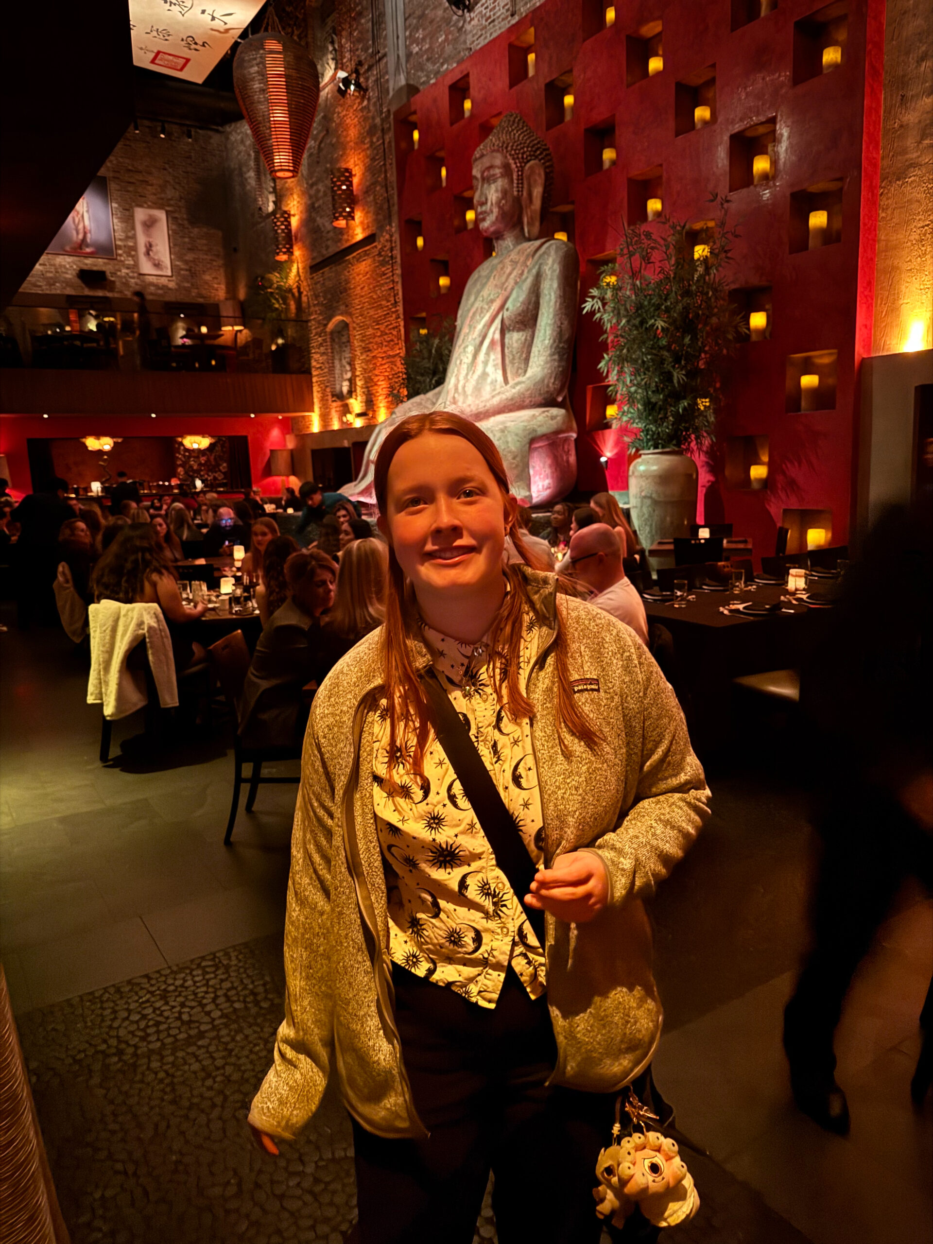 Cameron standing for a photo in front of the giant Buddha in Tao in Las Vegas. 