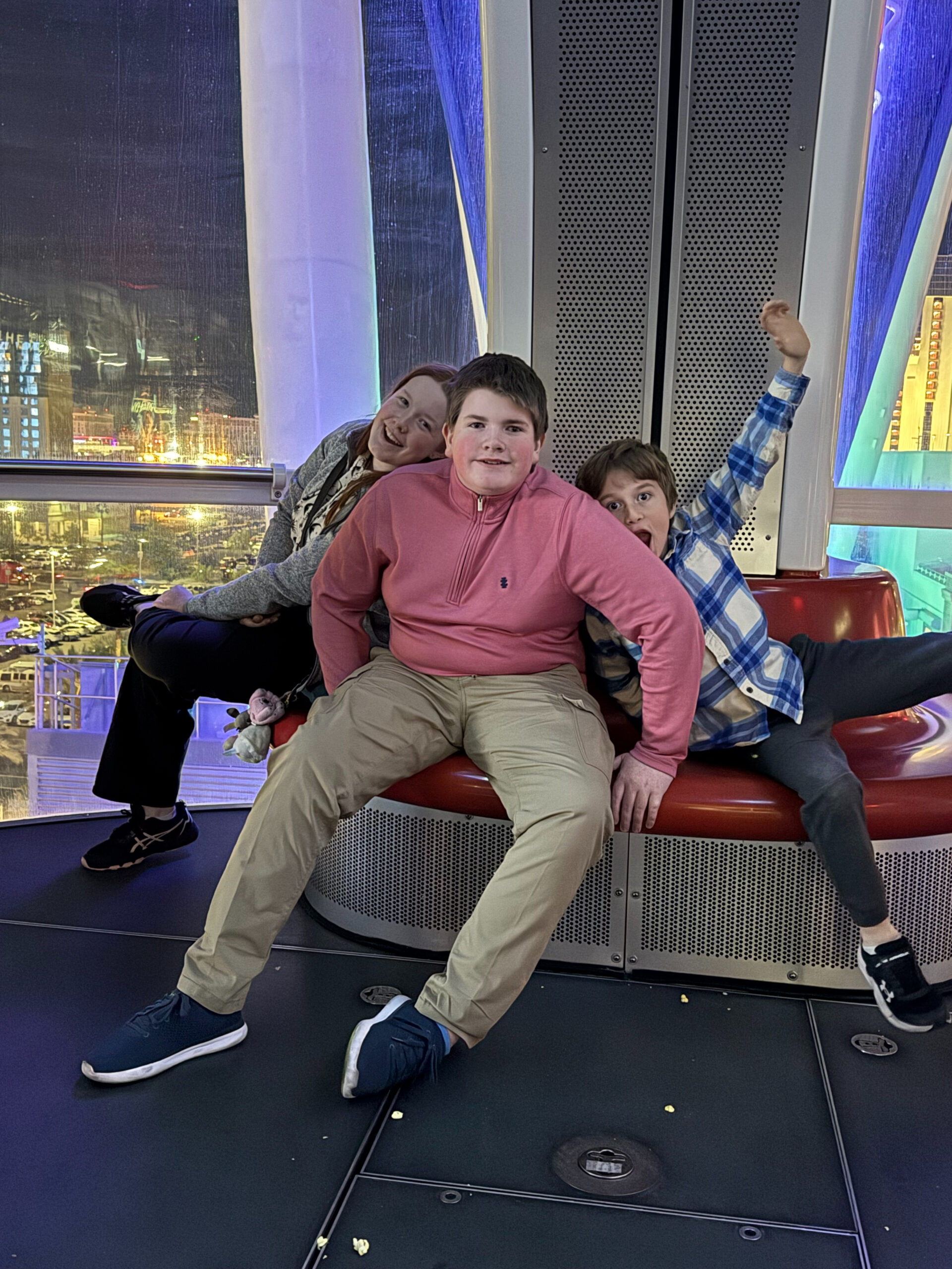 Cameron, Collin and Nate sitting together on the High Roller Ferris Wheel at night in Las Vegas. 