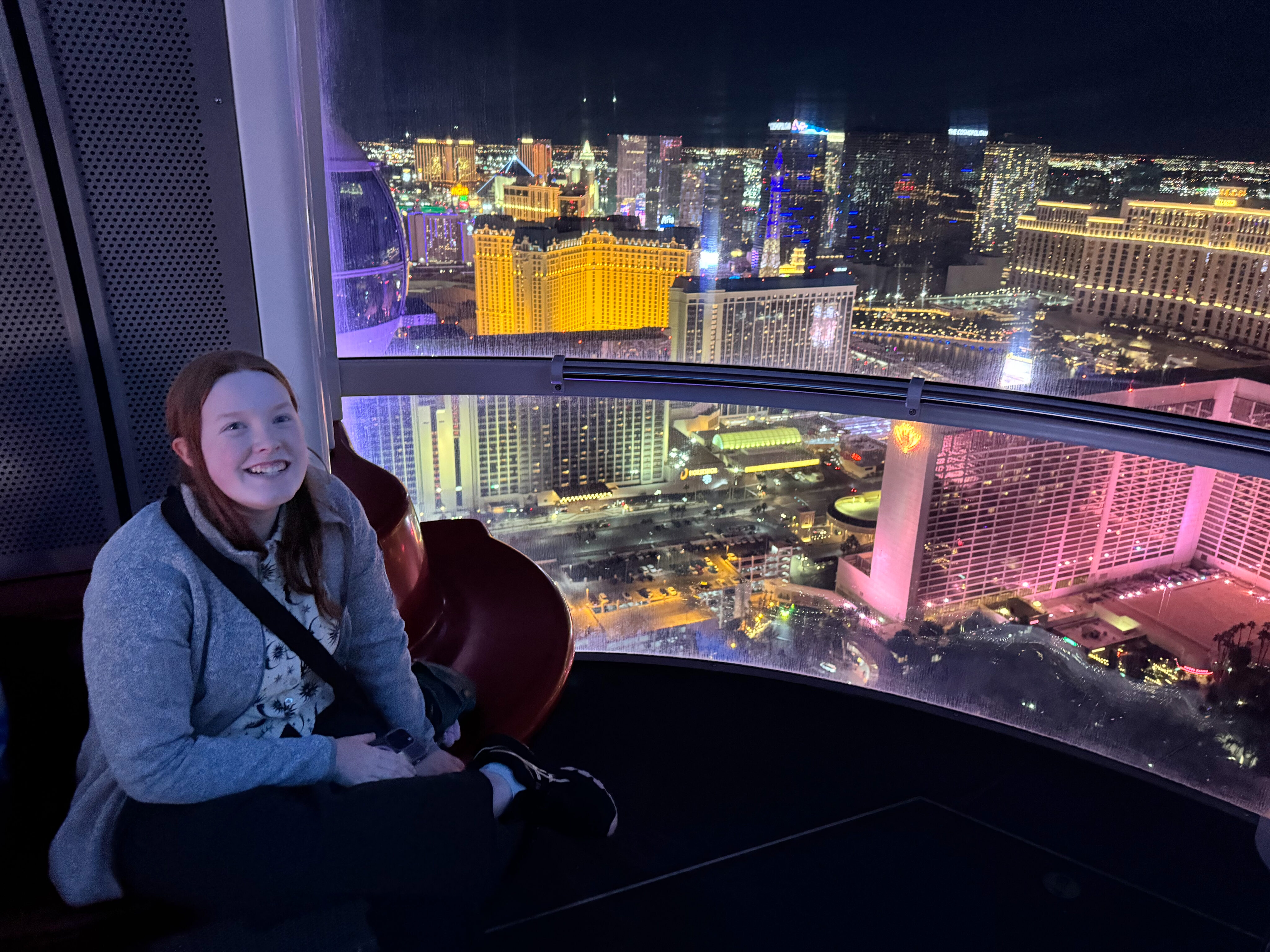 Cameron at night on The High Roller, the tallest Ferris Wheel in the world with the entire Las Vegas Skyline behind her.