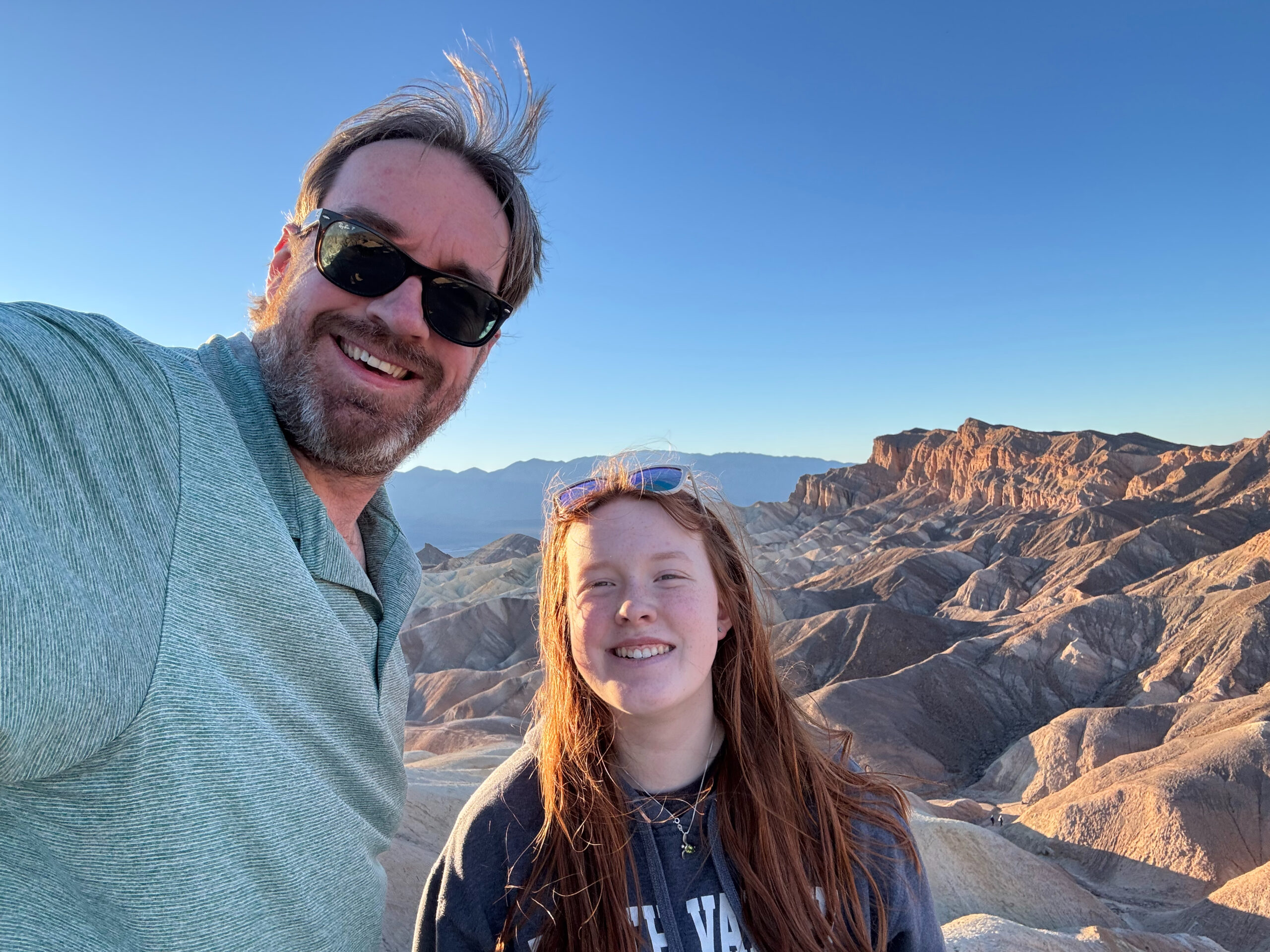 Chris and Cameron standing in the early morning light at Cat, Collin and Cameron walking down the trail from the overlook at Zabriskie Point just after sunrise. 