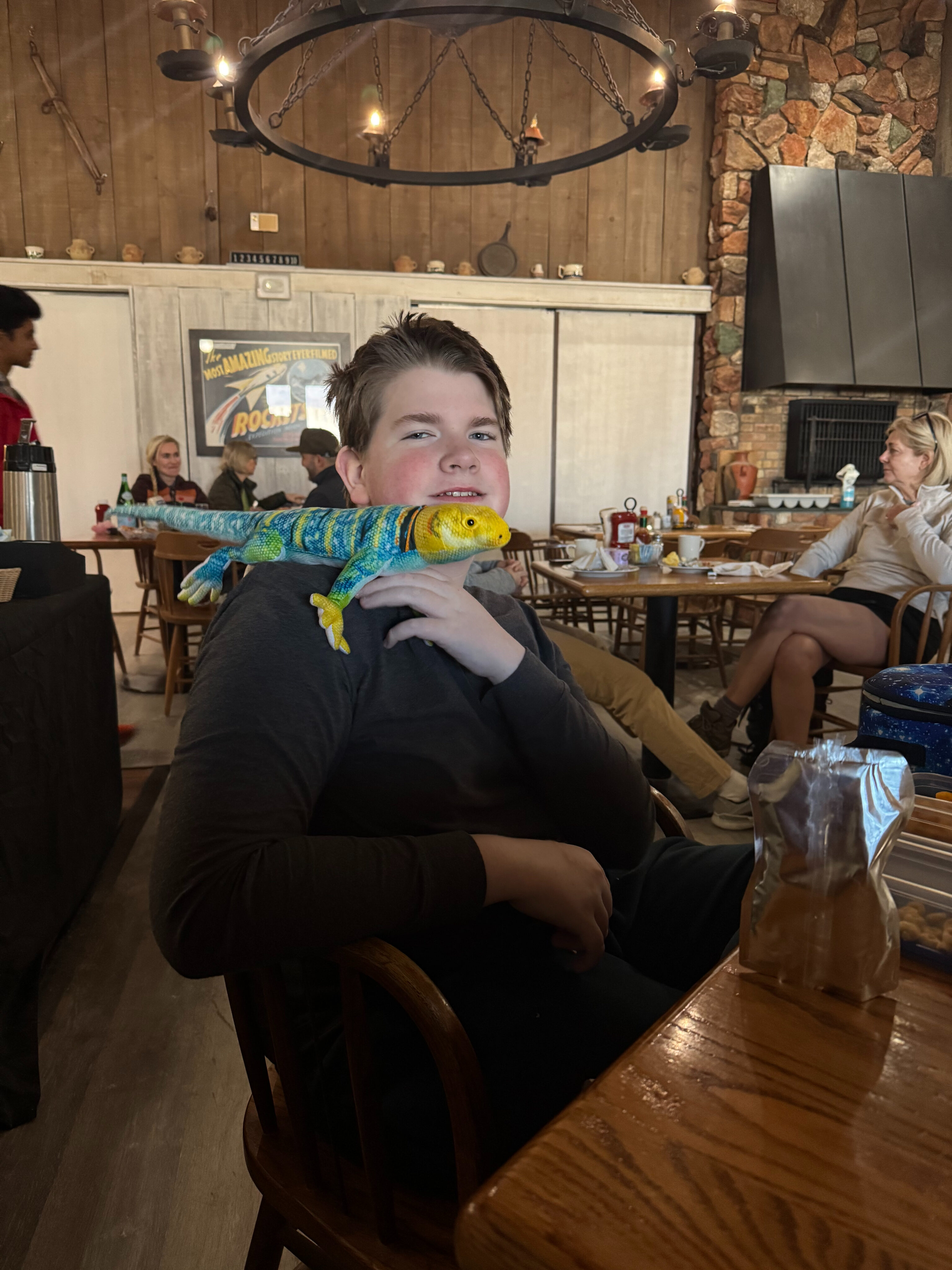 Collin at breakfast at Stovepipe Wells - with a stuffed animal lizard on his shoulder. 