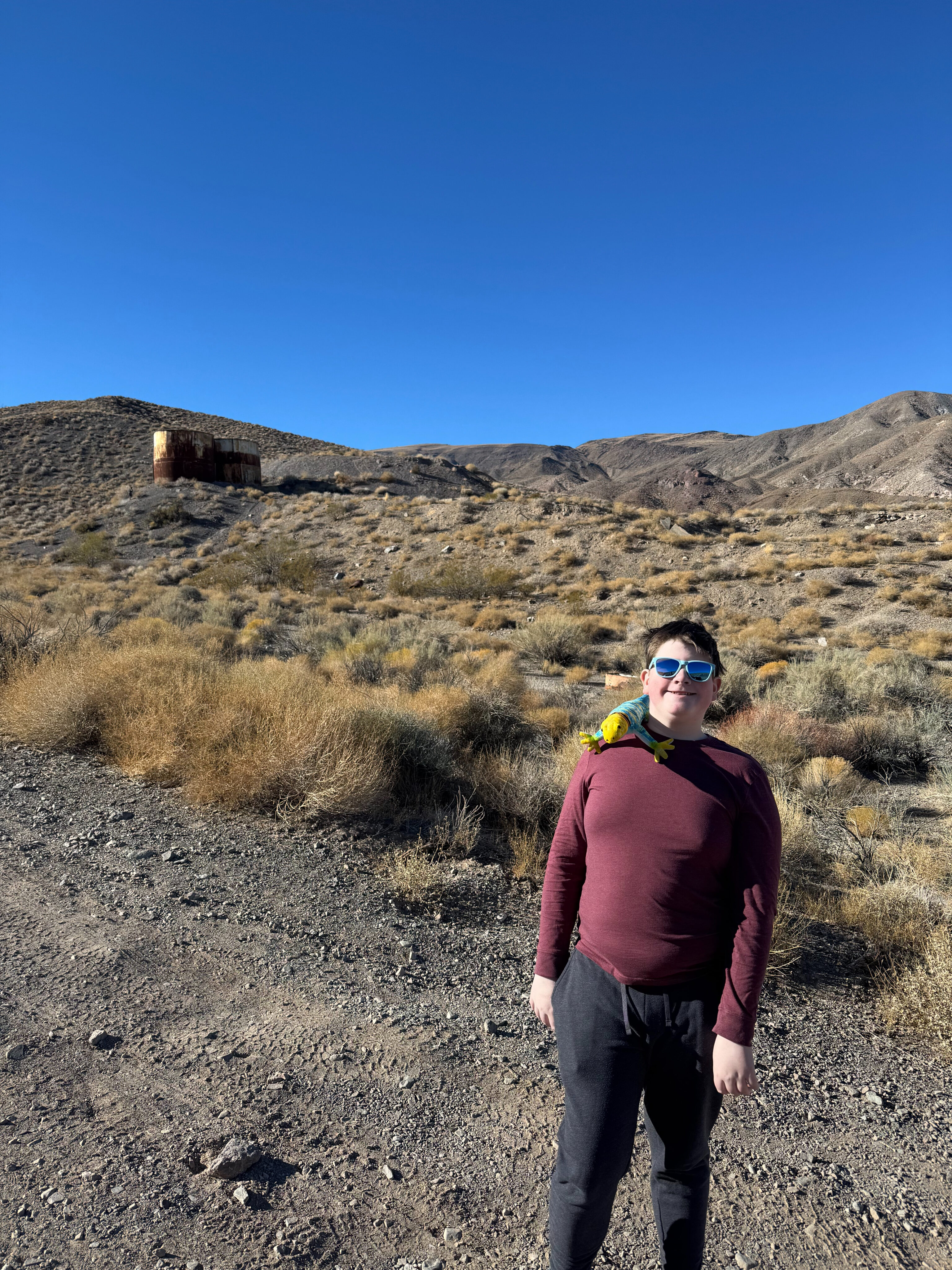 Collin poses for a photo on a bluebird day at the Journigan's Mill site in Death Valley.