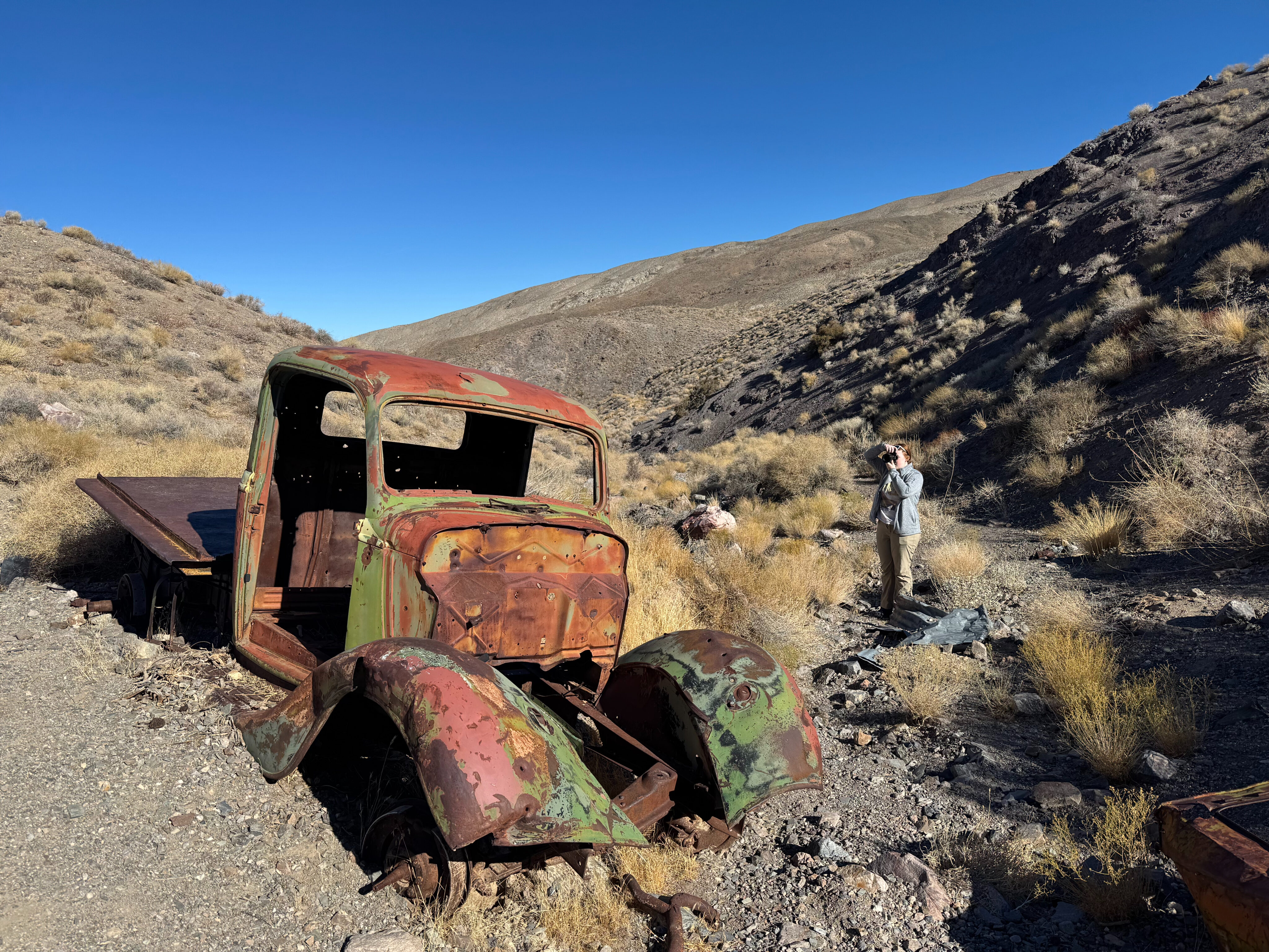 Cameron exploring the Journigan's Mill Site in Death Valley - where old remains of a car are left deep in the desert.