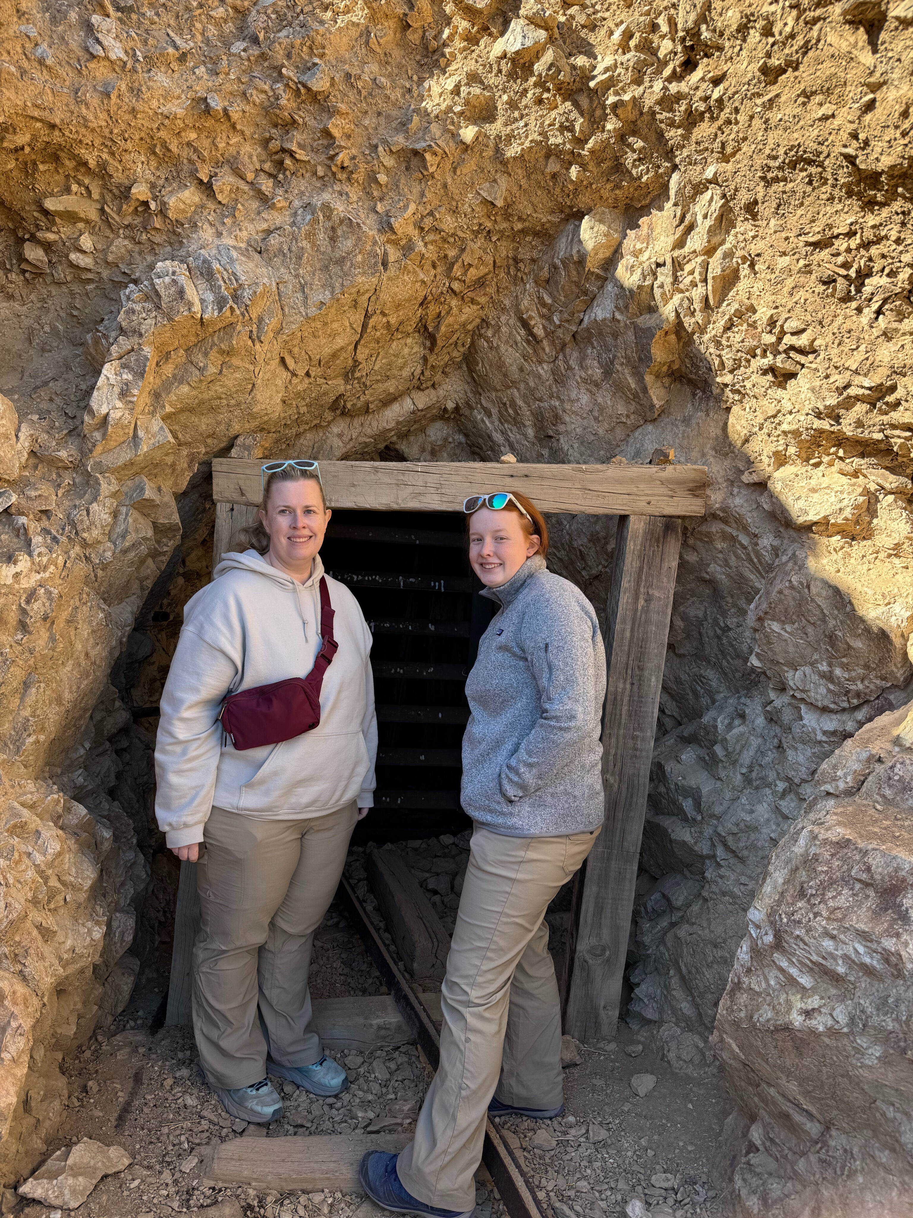 Cat and Cameron stand at the entrance  to what was the Eureka Mine site