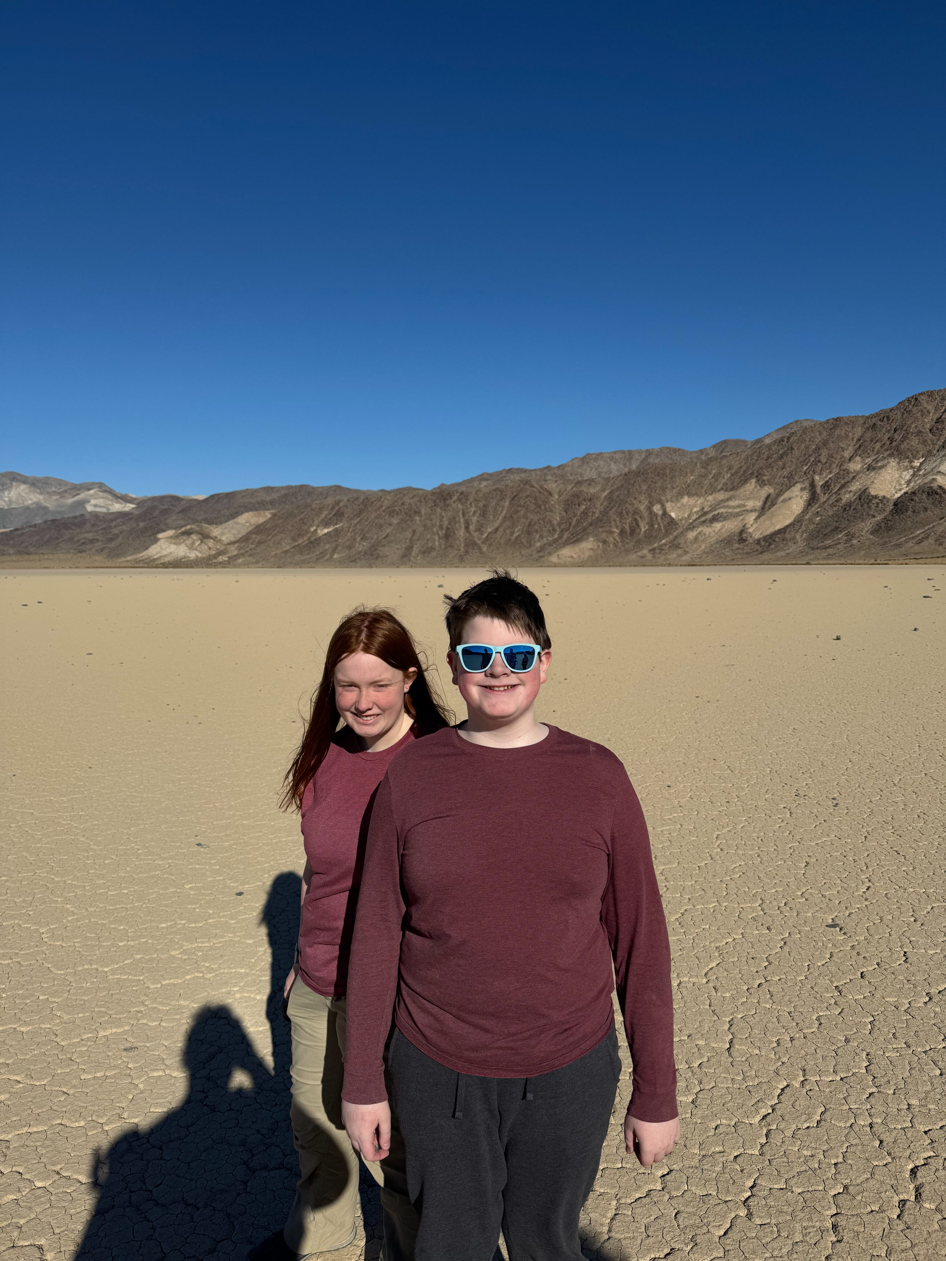 Collin and Cameron standing on the middle of the Racetrack Playa deep in the valley inside Death Valley National Park.