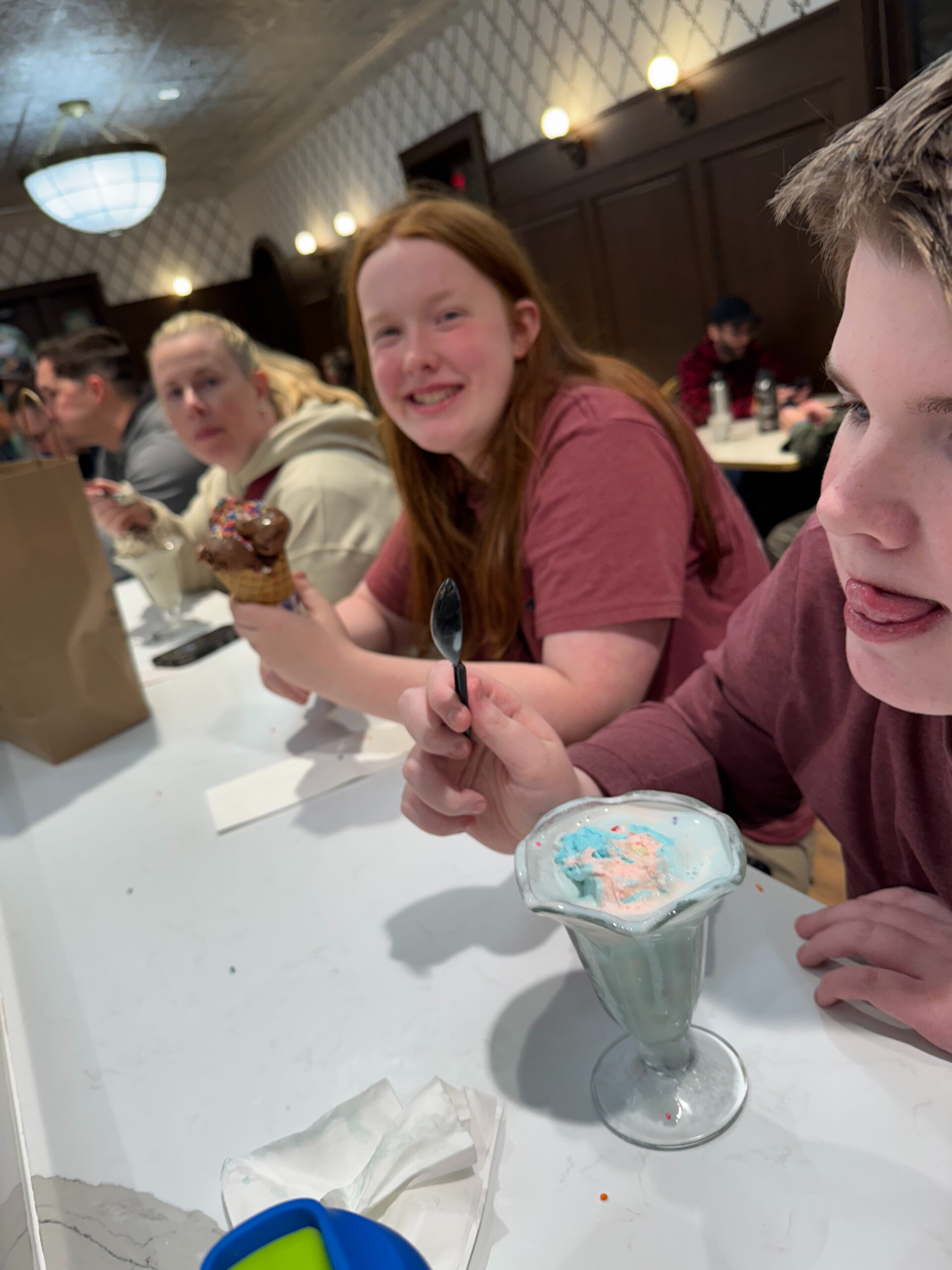 Collin, Cami and Cat in the Ice Cream Parlor at night at the Ranch at Death Valley. All eating their ice cream.