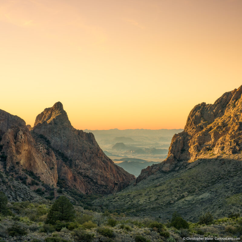 Sunset view from The Window in Big Bend National Park, highlighting the luminous glow on the Chisos Mountains and the expansive valley below.