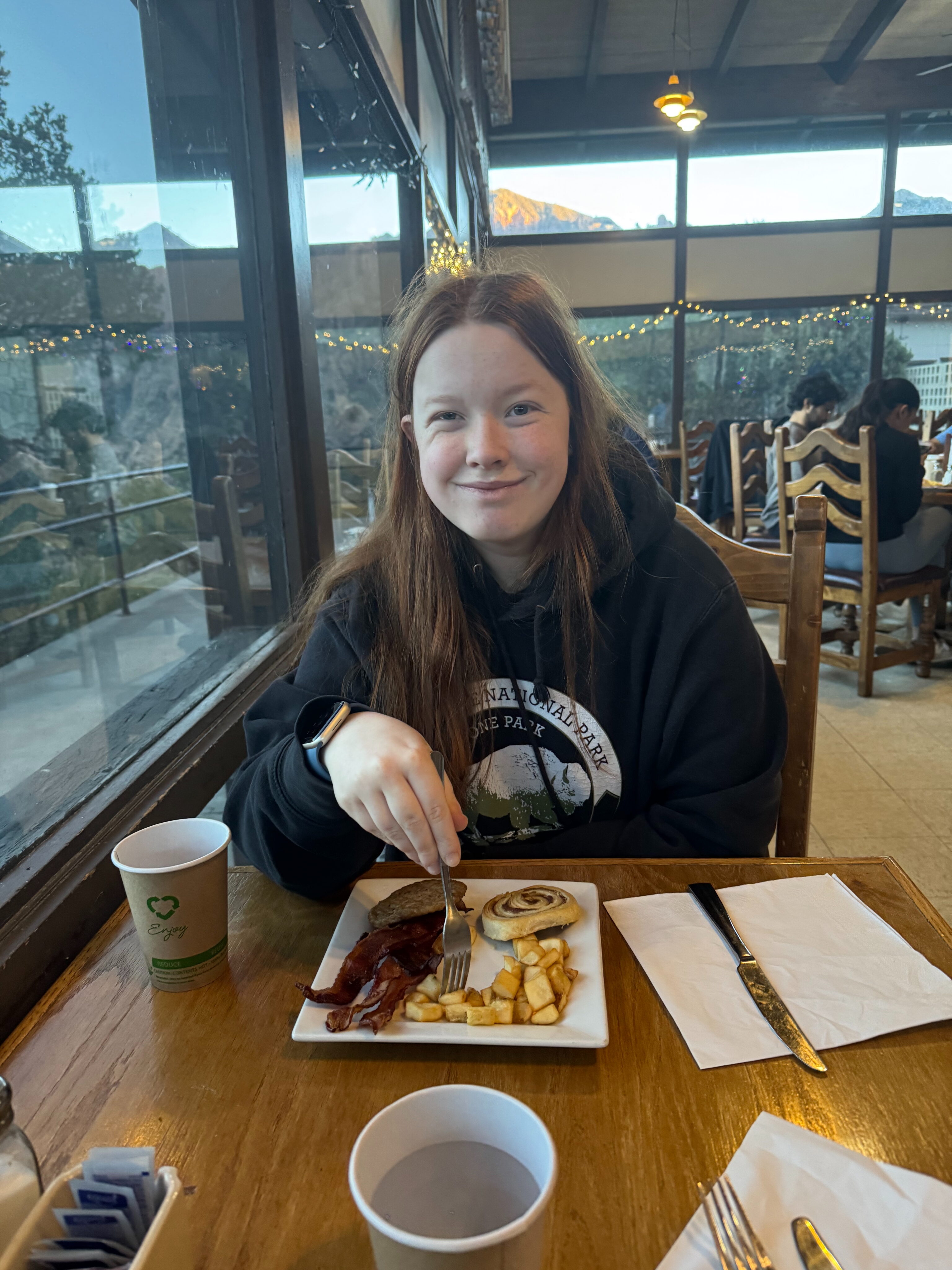 Cameron sitting by the windows overlooking the mountains in the Chisos Mountains Lodge Restaurant.