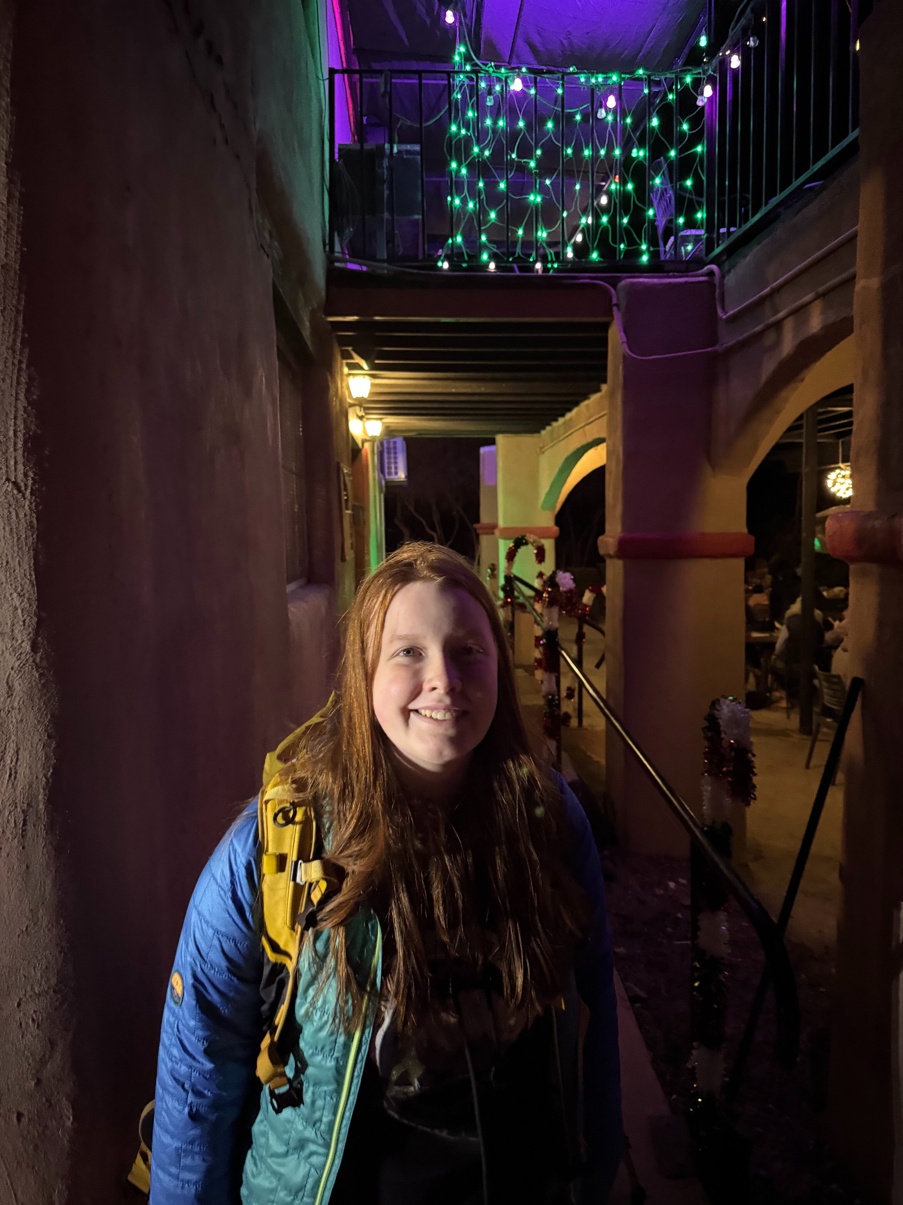 Cameron stops to pose for photo at night outside of the High Sierra Bar and Grill.