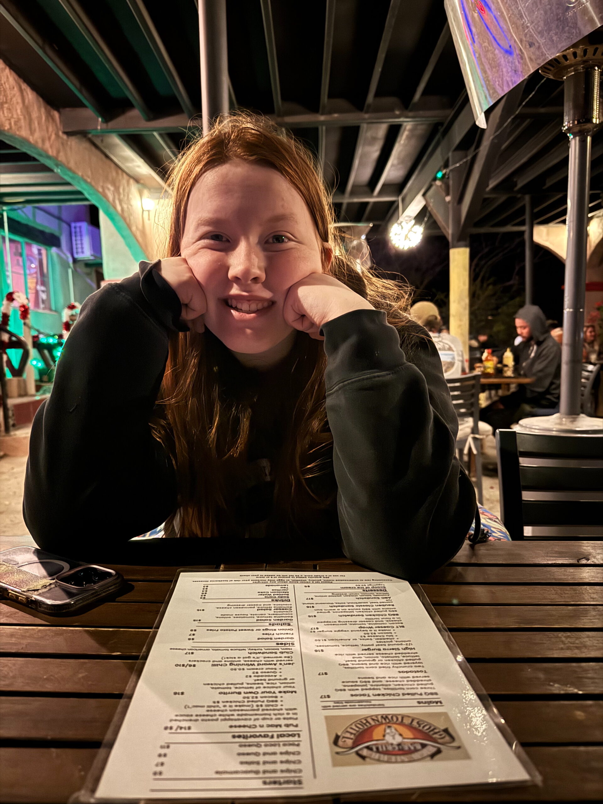 Cameron with her arms on the table, outside at the High Sierra bar and Grill.