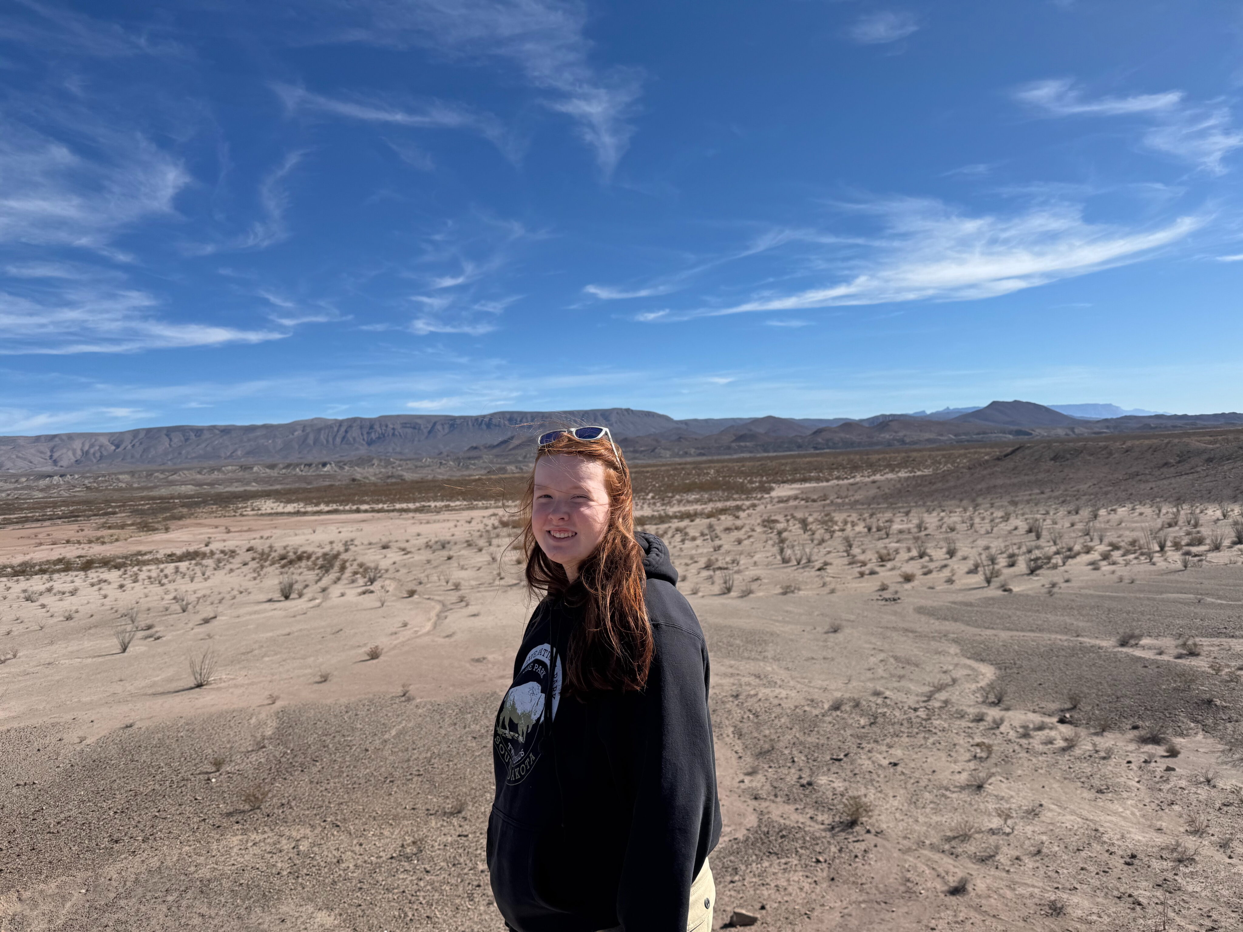 Cameron smiles as she stands in the vast open desert of Big Bend.